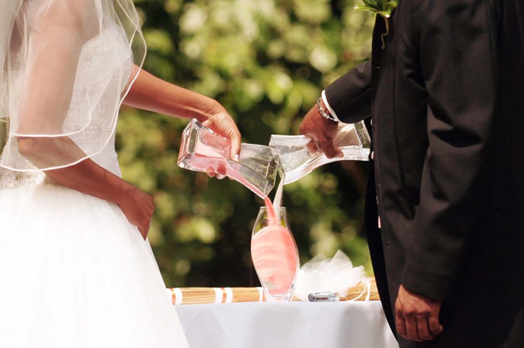 Sand Blending Ritual wedding ceremony led by DC officiant Starlene J. Burns, symbolizing unity and harmony for couples in DC, MD, and VA